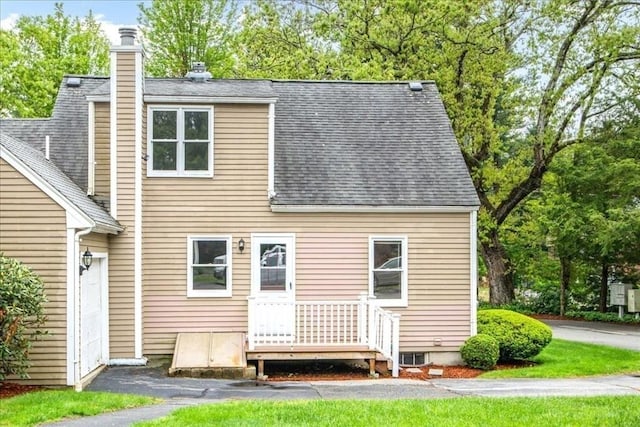 88 Cocasset St Unit 1, Foxboro, MA 02035 - rear view of property with a shingled roof, a chimney, and view of wooded area