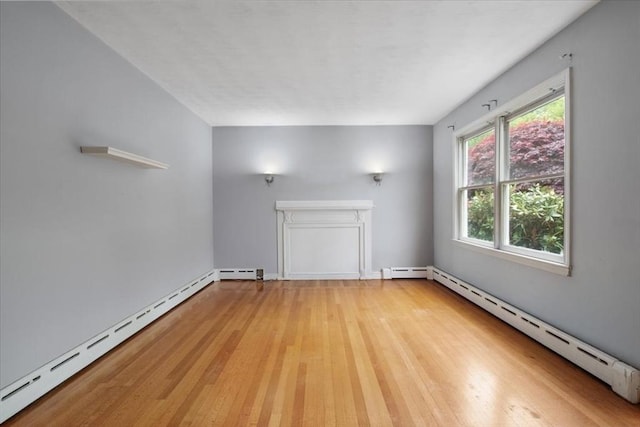 88 Cocasset St Unit 1, Foxboro, MA 02035 - unfurnished living room featuring a baseboard heating unit and light wood-style flooring