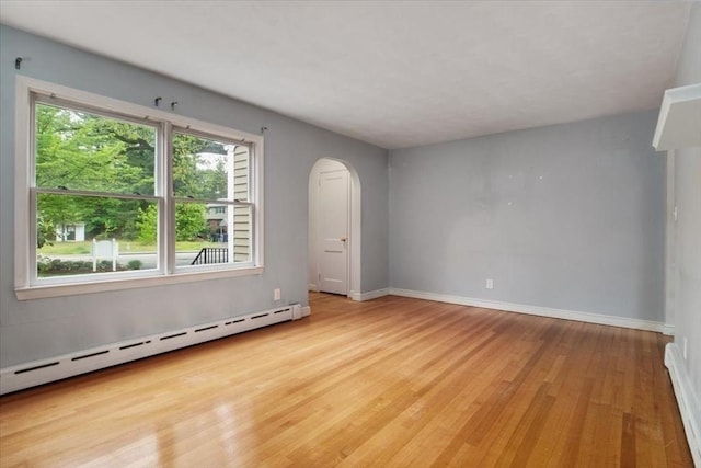 88 Cocasset St Unit 1, Foxboro, MA 02035 - unfurnished room with a baseboard radiator, arched walkways, wood finished floors, and baseboards