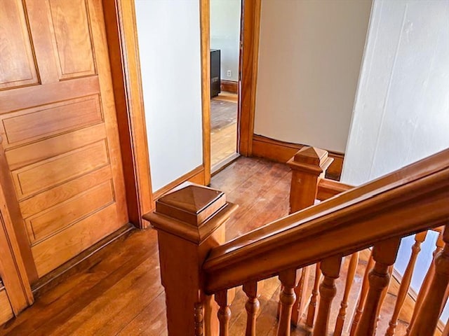 stairs featuring hardwood / wood-style floors