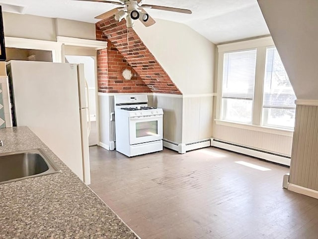kitchen featuring white appliances, ceiling fan, wood finished floors, a wainscoted wall, and lofted ceiling