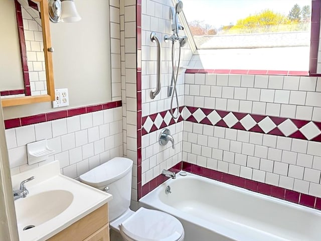 full bathroom with tile walls, shower / bath combination, toilet, and vanity