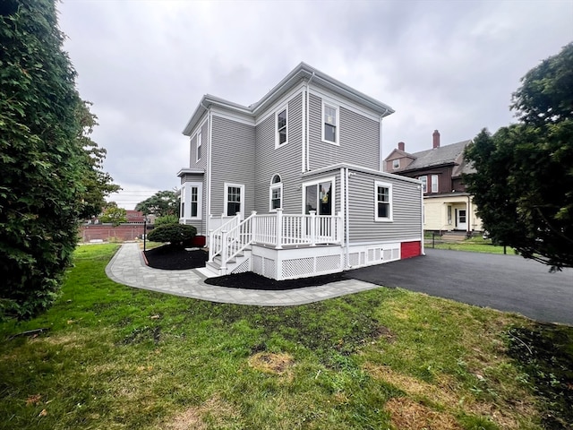 back of house with a lawn