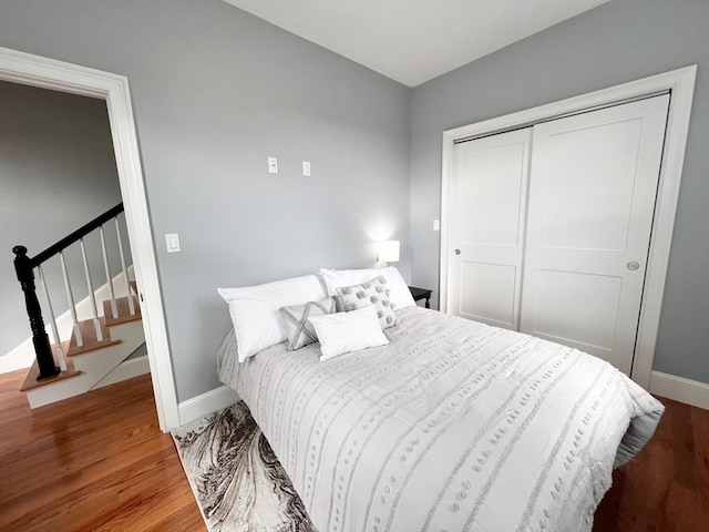 bedroom with wood-type flooring and a closet