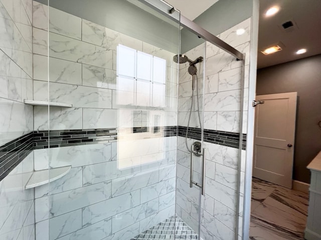 bathroom featuring a shower with shower door