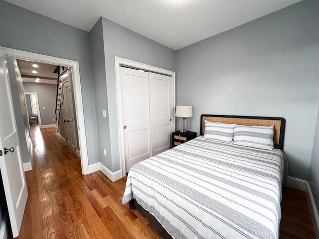 bedroom featuring wood-type flooring and a closet