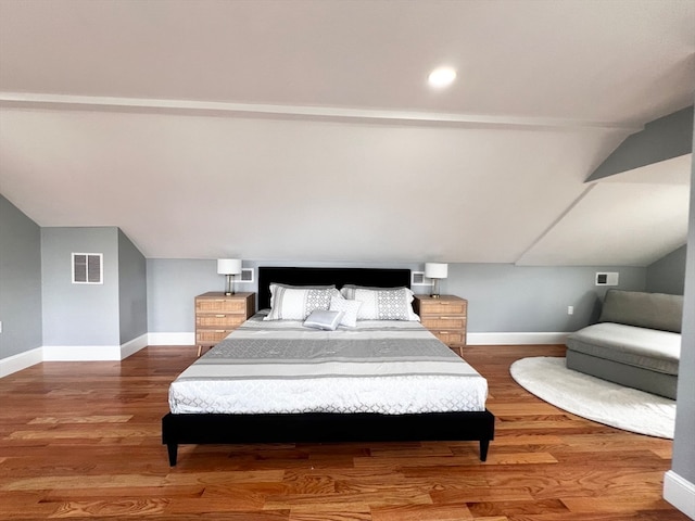 bedroom featuring vaulted ceiling and hardwood / wood-style flooring