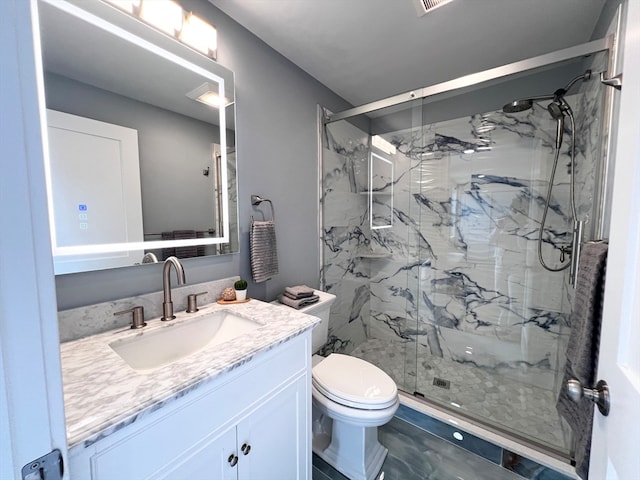 bathroom featuring vanity, toilet, and walk in shower