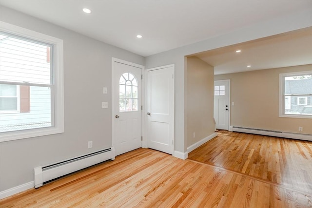 foyer featuring a baseboard radiator, healthy amount of natural light, and recessed lighting