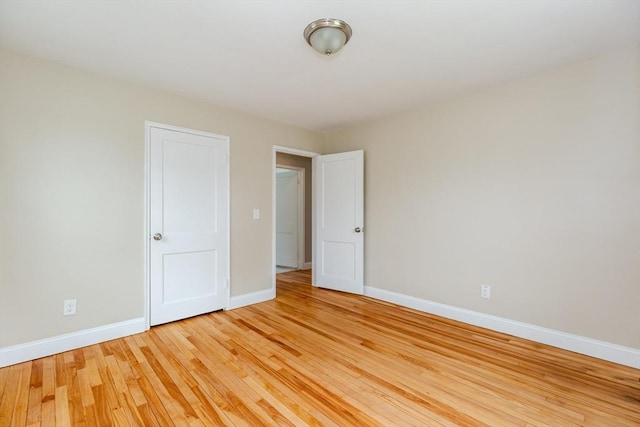 unfurnished bedroom featuring baseboards and light wood-type flooring