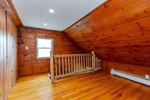 bonus room with light wood-type flooring, vaulted ceiling, wood walls, a baseboard heating unit, and recessed lighting