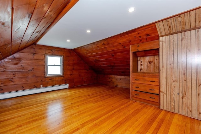 bonus room featuring wood walls, wood finished floors, baseboard heating, vaulted ceiling, and recessed lighting
