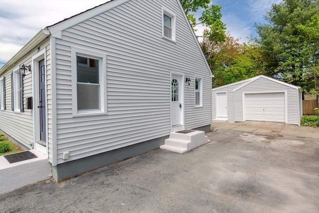 view of side of property with an outdoor structure and a garage