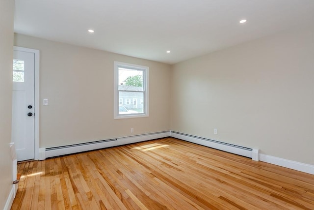 unfurnished room featuring plenty of natural light, hardwood / wood-style flooring, baseboards, recessed lighting, and a baseboard radiator