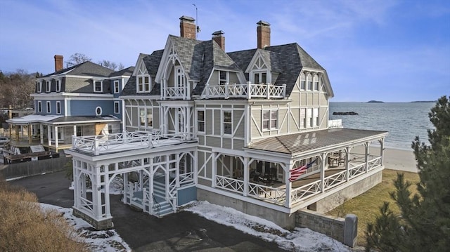 back of property featuring a water view