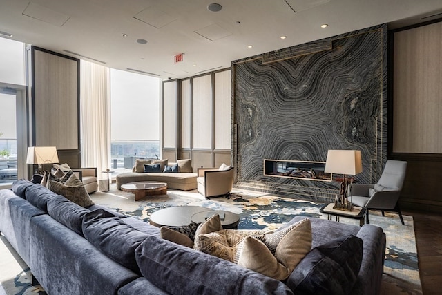 living room featuring a wealth of natural light, a large fireplace, and floor to ceiling windows