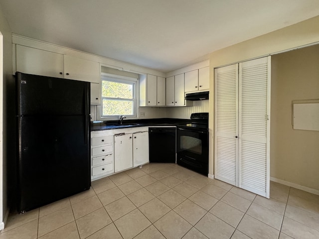 kitchen featuring sink, white cabinets, black appliances, and light tile patterned floors