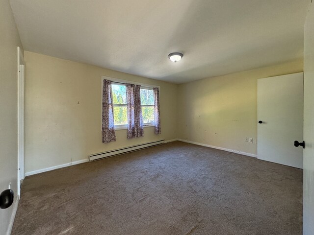 carpeted spare room featuring a baseboard radiator