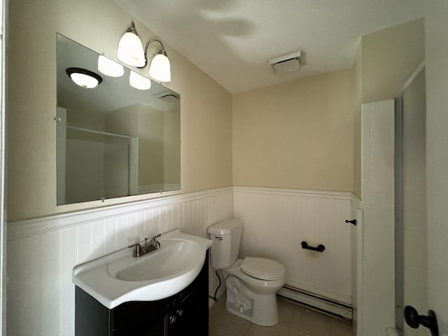 bathroom with walk in shower, vanity, a baseboard radiator, tile patterned flooring, and toilet