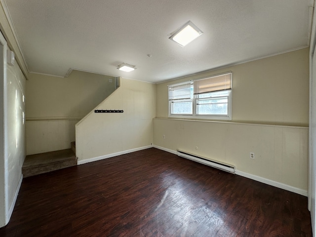 additional living space with a textured ceiling, dark wood-type flooring, and a baseboard radiator