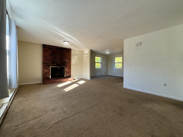 unfurnished living room featuring carpet, a textured ceiling, a brick fireplace, and a baseboard heating unit