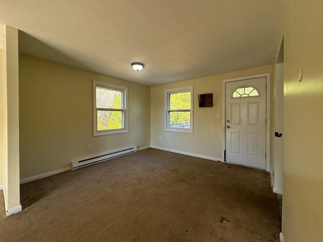 carpeted foyer featuring a textured ceiling and a baseboard heating unit