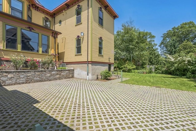 929 Beacon St, Newton, MA 02459 - view of property exterior featuring a patio area and a lawn