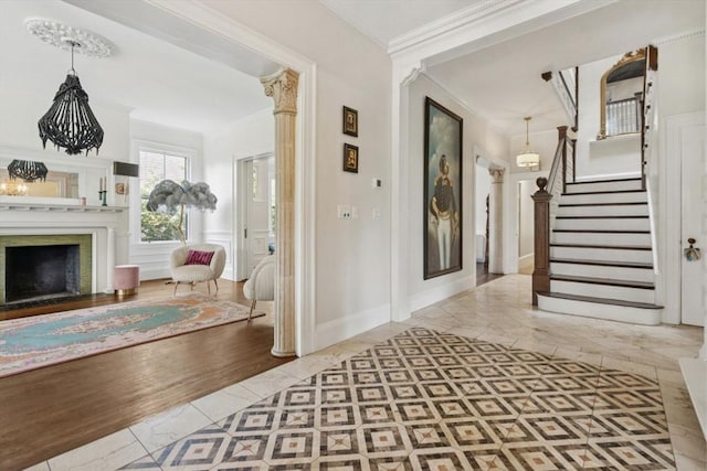929 Beacon St, Newton, MA 02459 - entrance foyer with crown molding, a fireplace, stairs, and inlaid floor details