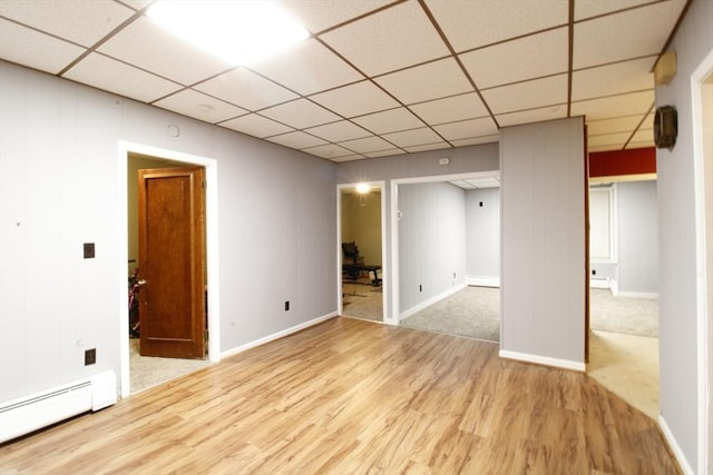 empty room with light hardwood / wood-style floors and baseboard heating