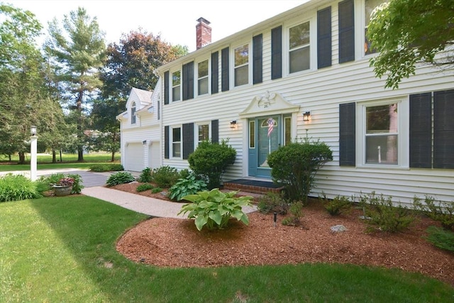 26 Kittredge St, Walpole, MA 02081 - colonial-style house with a chimney, a front yard, and a garage