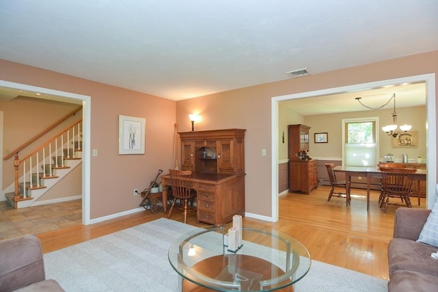 26 Kittredge St, Walpole, MA 02081 - living area with light wood-style flooring, stairway, baseboards, and a chandelier