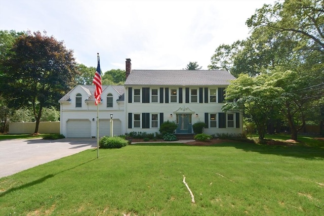 26 Kittredge St, Walpole, MA 02081 - colonial home featuring driveway, a chimney, an attached garage, and a front yard