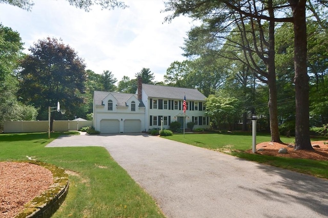 26 Kittredge St, Walpole, MA 02081 - colonial house featuring asphalt driveway, a chimney, and an attached garage