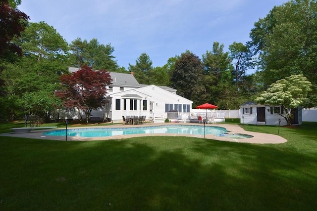 26 Kittredge St, Walpole, MA 02081 - rear view of property with an outdoor structure, a patio, view of wooded area, and a pool with connected hot tub