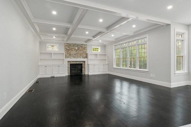 unfurnished living room with coffered ceiling, a stone fireplace, crown molding, built in shelves, and beam ceiling