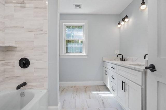 bathroom with vanity and tiled shower / bath combo