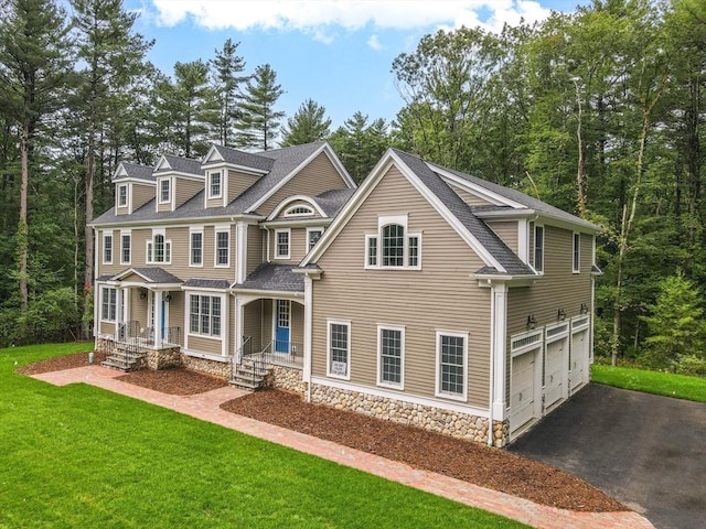 view of front of house with a garage and a front lawn