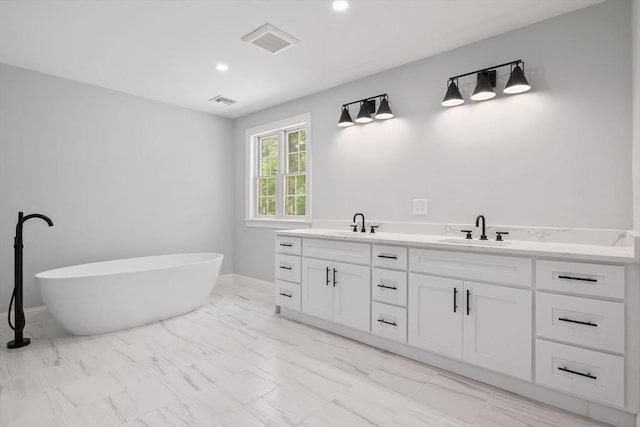 bathroom featuring a tub and vanity