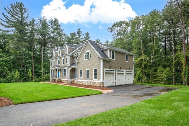 view of front of house with a front yard and a garage