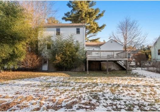 back of house with a wooden deck