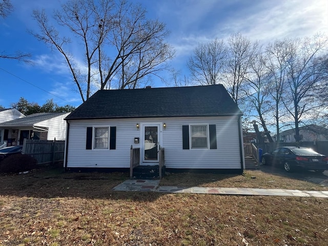 bungalow-style home with a front lawn