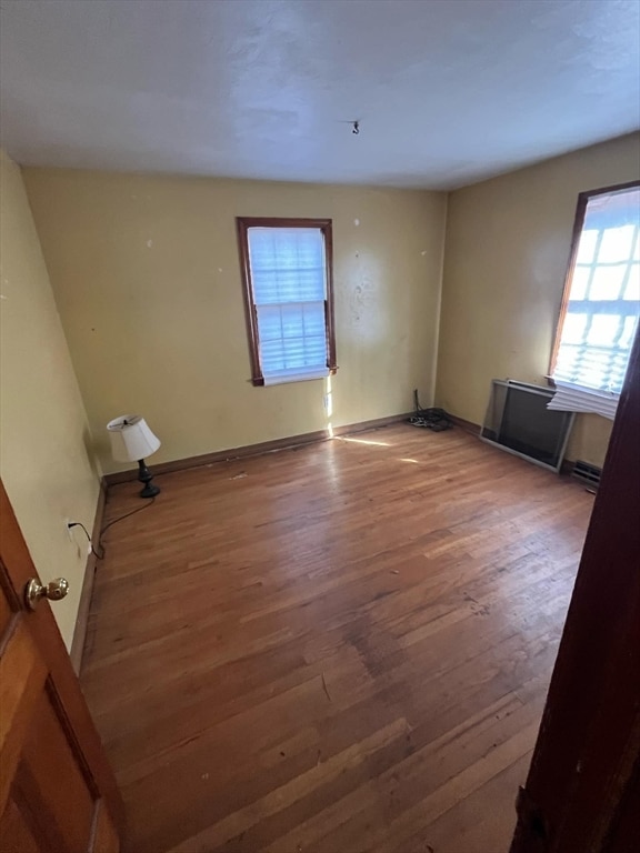 spare room with hardwood / wood-style floors