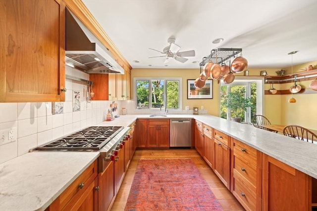 21 Fremont St, Dartmouth, MA 02748 - kitchen featuring stainless steel appliances, wall chimney exhaust hood, a ceiling fan, and light countertops