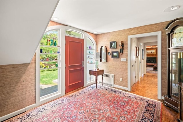 21 Fremont St, Dartmouth, MA 02748 - foyer entrance with radiator heating unit, baseboards, wallpapered walls, and wood finished floors