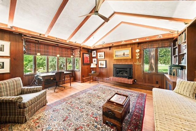 21 Fremont St, Dartmouth, MA 02748 - living area featuring a ceiling fan, wood finished floors, wooden walls, and a fireplace with raised hearth