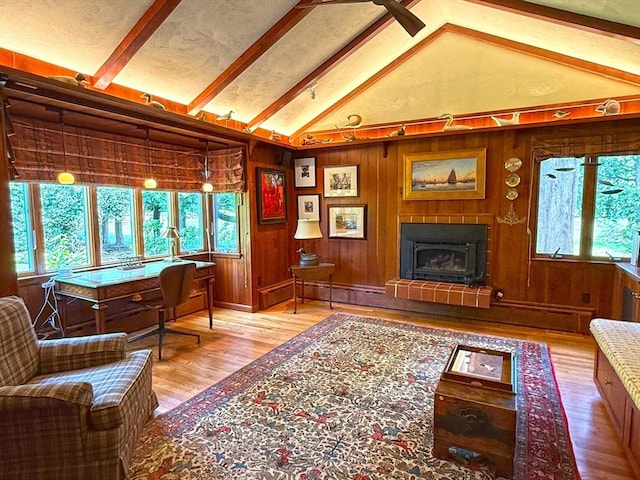 21 Fremont St, Dartmouth, MA 02748 - living area with wood finished floors, a fireplace with raised hearth, wooden walls, and ceiling fan