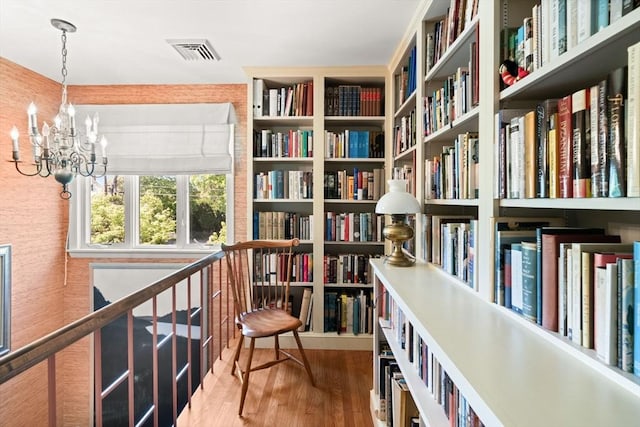 21 Fremont St, Dartmouth, MA 02748 - living area featuring bookshelves, wood finished floors, and a chandelier