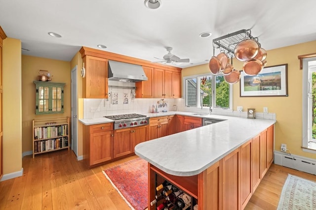 21 Fremont St, Dartmouth, MA 02748 - kitchen featuring wall chimney range hood, appliances with stainless steel finishes, a peninsula, open shelves, and light countertops