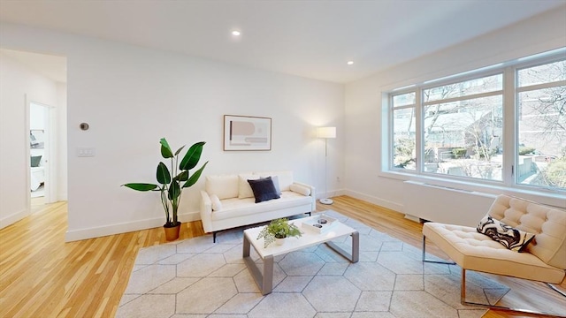 living area featuring recessed lighting, baseboards, and light wood finished floors