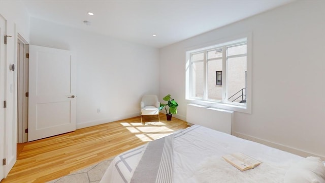 bedroom with recessed lighting, baseboards, and wood finished floors